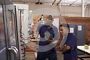 Engineer Training Young Male Apprentice On CNC Machine