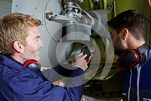 Engineer training young male apprentice