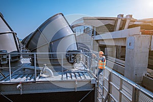 A engineer under checking the industry cooling tower air conditioner is water cooling tower air chiller HVAC of large industrial b