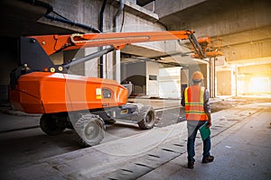 A engineer under inspection and checking construction process railway ,straight Boom Lift to construction roof on sky rail train b