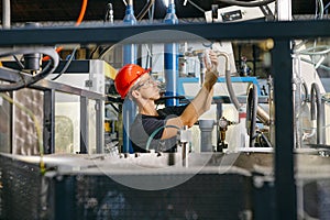 Engineer in uniform helmet inspection check control heavy machine