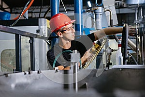 Engineer in uniform helmet inspection check control heavy machine