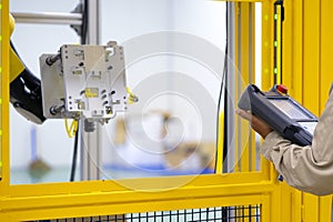 An engineer use controller for setting robot