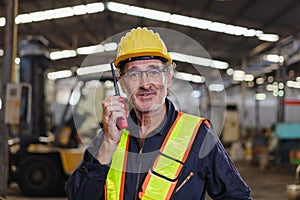 engineer use walkie talkie at machine factory