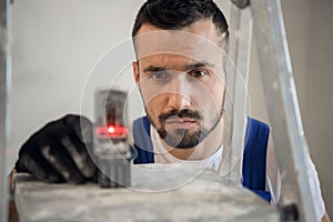 The engineer uses an electronic ruler, close-up