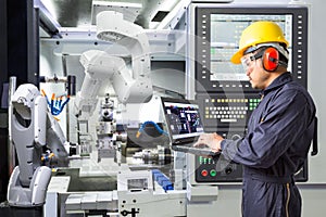 Engineer using computer for maintenance automatic robotic industry
