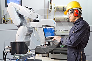 Engineer using computer for maintenance automatic robotic industry