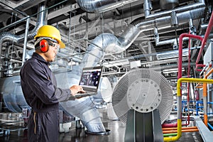 Engineer using computer for maintenance in thermal power plant