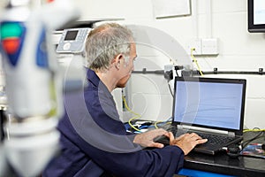 Engineer Using Computerized CMM Arm In Factory