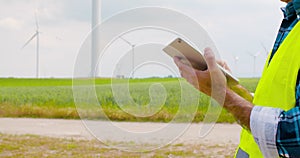 Engineer using digital tablet when doing wind turbine inspection