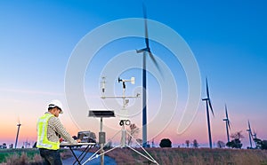 Engineer using laptop computer collect data with meteorological instrument to measure the wind speed, temperature and humidity and