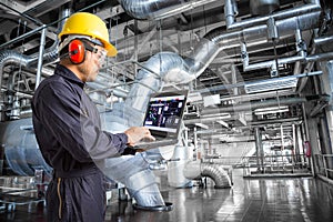 Engineer using laptop computer in the factory