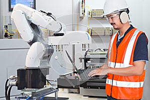 Engineer using laptop computer for maintenance automatic robotic