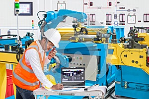 Engineer using laptop computer for maintenance automatic robotic