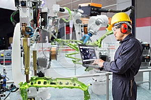 Engineer using laptop computer maintenance automatic robotic han