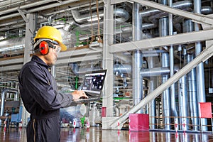 Engineer using laptop computer for maintenance equipment