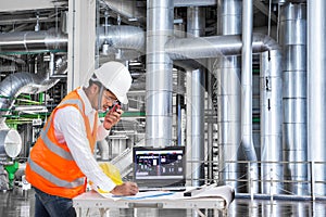 Engineer using laptop computer for maintenance equipment