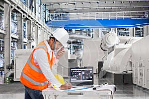 Engineer using laptop computer for maintenance equipment in powerhouse