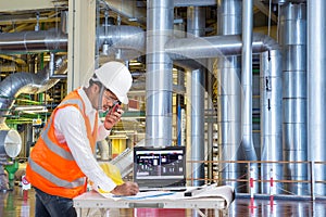 Engineer using laptop computer for maintenance equipment in thermal power plant factory