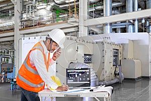 Engineer using laptop computer for maintenance in thermal power factory