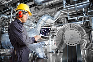 Engineer using laptop computer in thermal power plant factory