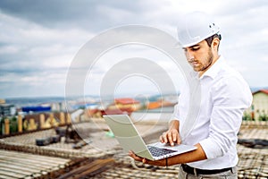 engineer using laptop on construction site. Industry details