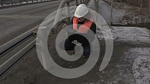 Engineer using laptop near the bridge and walking away