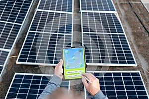 Engineer using solar system application. Checking solar panel setup.