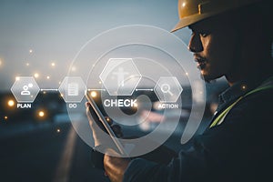 Engineer using tablet to inspect work at job site.