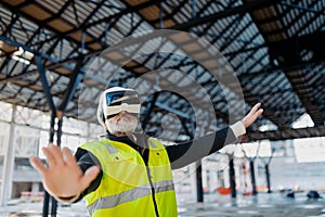 Engineer using virtual reality to inspect building progress.