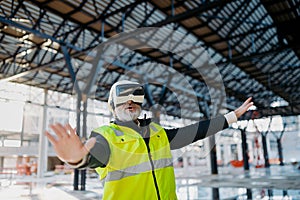 Engineer using virtual reality to inspect building progress.