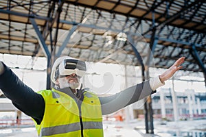 Engineer using virtual reality to inspect building progress.