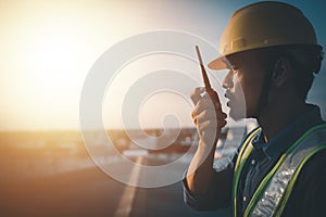 Engineer using walkie talkie and talking about work construction site