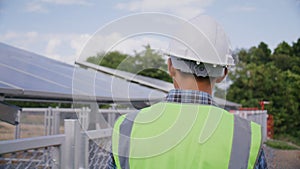 Engineer walk around solar cells station for checking system and maintenance solar panel