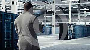 Engineer walking in server farm, automating system diagnostics