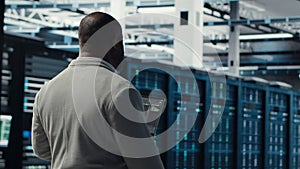 Engineer walking in server farm, automating system diagnostics