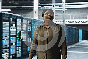 Engineer walking through server farm rows lined with storage infrastructure