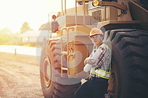 Engineer holding blueprint in construction site