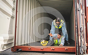 Engineer wear PPE urgently assisted the male technique inside container as Chemical spill in the container shipping industry