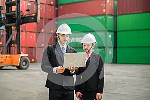 Engineer wearing a hardhat standing cargo at the container yard and Check container integrity Before exporting products abroad