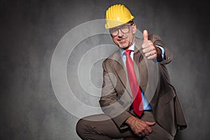 Engineer wearing helmet and glasses showing thumbs up