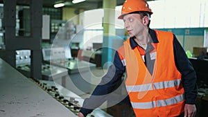 Engineer wearing an orange protective mask, hand finger press button controling