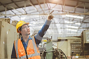 Engineer woker in factory hand rising. Asian staff pointing for future concept