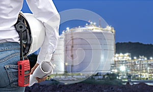 Engineer woman holding white helmet and blueprint with radio for workers security control at power plant energy industry.