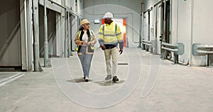Engineer woman, man and walking in warehouse for planning discussion for manufacturing, logistics or industry. Teamwork