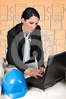 Engineer woman in office with laptop