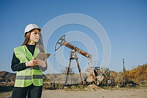 Engineer Woman Work on Digital Tablet. Portrait of Professional Female Engineer Wearing Safety Uniform and Hard Hat