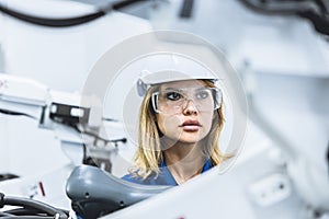 engineer woman worker working with robotic arm in productions lab research industry factory