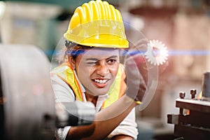 Engineer worker looking at steel gear part, working precise and most accuracy high performance doing best job