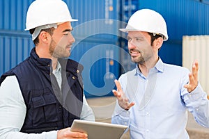 Engineer and worker speaking about work on the dock